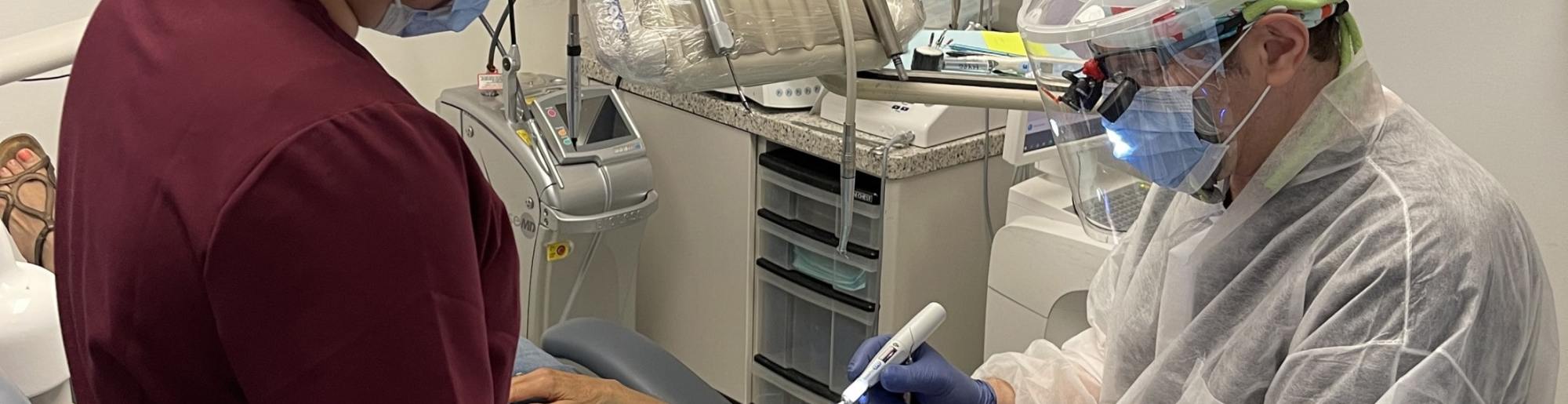 Dr. Whiteman providing dental care to patient